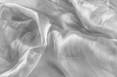 Arka plan doku, desen. Kumaş beyazdır. Beyaz ipek kumaş arka plan narin ve zarif. Parlak saten kumaş, katlanmış bir arka plan olarak kullanmak için. Kumaş Tekstil yüzey üst türü. 