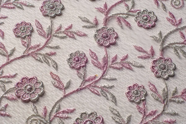Tekstury, tła, wzór. Różowe koronki ozdobione kwiatami o — Zdjęcie stockowe