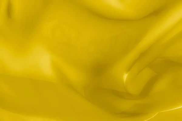 Texture, background, pattern. Yellow transparent silk fabric. Sunshine Yellow Silk Charmeuse Satin,