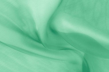 Doku, arka plan, desen. Soluk yeşil ipek kumaş. Bu pek de yumuşak ve ince tül, yumuşak ipek tül var. Görünüşe göre bir perdelik, bir düğün hayal çok yumuşak