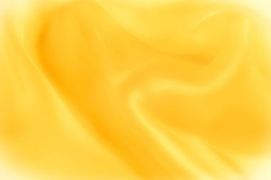 Fotoğraf bulanık. Doku, arka plan, desen. Sarı ipek kumaş. Arka plan lüks sarı kumaş ya da sıvı dalga veya dalgalı doku. Tüm arka plan.