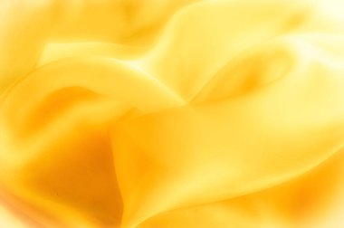 Fotoğraf bulanık. Doku, arka plan, desen. Sarı ipek 