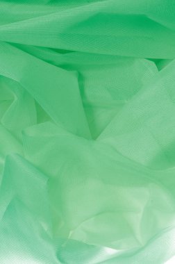 Doku, arka plan, desen. İpek kumaş dokusuna yeşildir. İpek kumaş saydamdır. İpek saten doku veya kadife malzeme dalgalı kırışıklıklar kumaş ya da sıvı dalga gösterimi 