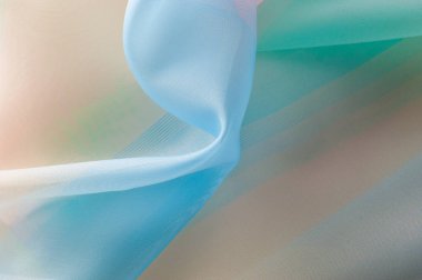 Doku, arka plan, desen. İpek kumaş şeffaf, sarı-pembe yeşil mavi olduğunu. Soyut yumuşak şifon doku arka plan. 