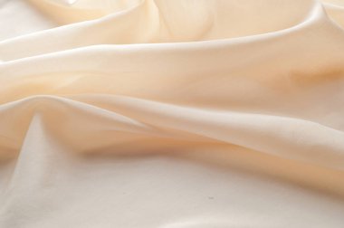 Doku arka plan desen kumaş ipek yumuşak dondurma. Kumaş perfectionists için-mutlak en iyi kalite % 100 saf ipek tül güzel bir yumuşak krem. Gelin peçe için en çok arzu edilen kumaş olduğunu 