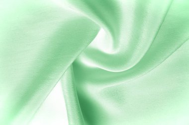 Doku arka plan deseni. Yeşil ipek kumaş. Closeup oluklu yeşil ipek kumaş. Reklam alanı. Pürüzsüz zarif yeşil ipek düğün arka plan olarak kullanılabilir.