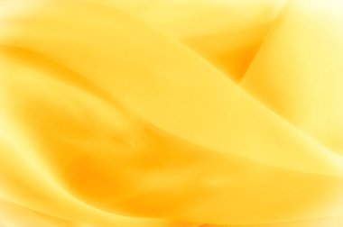 Fotoğraf bulanık. Doku, arka plan, desen. Sarı ipek 