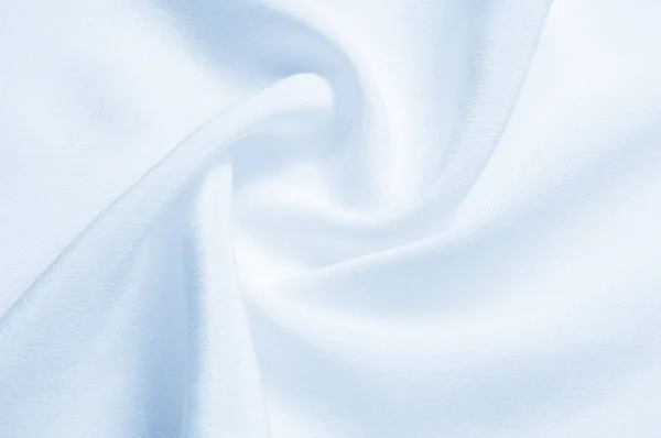 Texture background pattern. Blue silk fabric. Closeup of a rippl