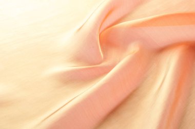 Arka plan doku, desen. Kumaş turuncu olduğunu. Sarı ipek kumaş arka plan güzel ve yumuşak olur. Bir arka plan olarak kullanmak için parlak saten kumaş katlanmış. Kumaş Tekstil yüzey üst türü. Metin alanı