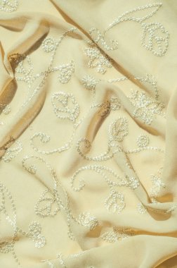 Doku, arka plan, desen. Kadın renk şal. Altın Başak. Limon kremalı. Navajo beyazdır. Eski altın. ipek kumaş.