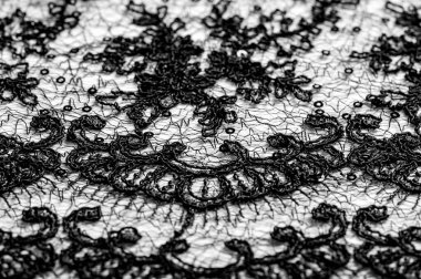 Doku, desen, beyaz bir arka plan üzerinde siyah dantel kumaş. Th