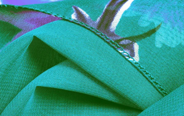 Tekstur, bakgrunn, grønt silkestoff med blått blomstertrykk . – stockfoto