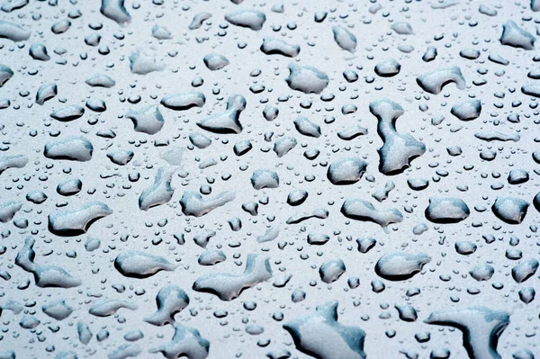 Summer rain, drops of water on the car paint. a small round or p — Stock Photo, Image
