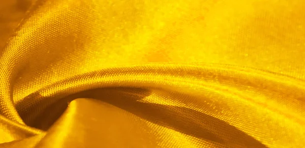 Текстура, фон, узор, шелковая ткань желтого цвета. Это дораb — стоковое фото