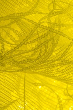 Doku, arka plan, desen. sarı tül. Basit bir tasarıma sahip