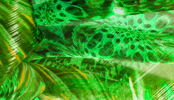 Background texture, pattern. Silk from a greenish emerald shade. This luxurious silk chiffon fabric is a show-stopper. It is clean, has a liquid drape and ultra soft. It is perfect for your design.