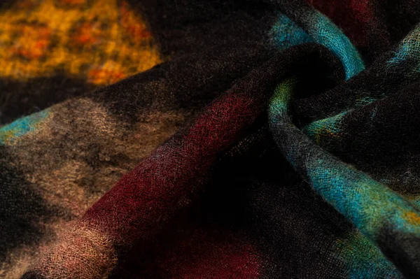 Texture, background, wool fabric in black with a colorful butter