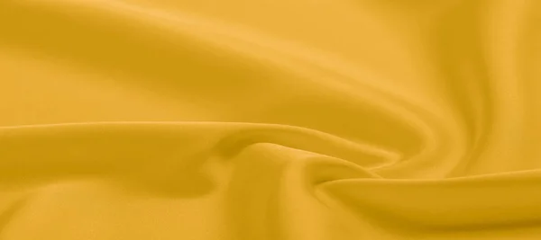 Текстура тла, візерунок. Жовта шовкова тканина. Дуже легкий фа — стокове фото