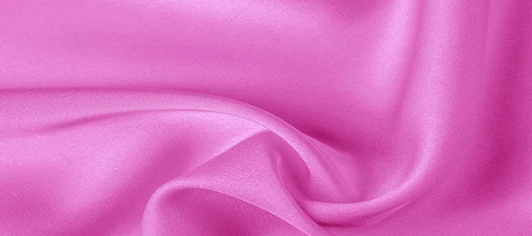 テクスチャ。ピンクのシルク生地。鮮やかな光沢と特徴 — ストック写真