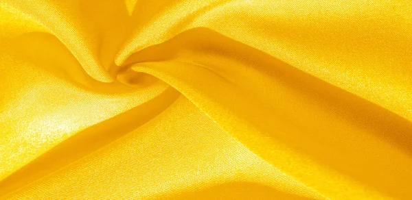 Texture, background, pattern, silk fabric in yellow. This silk i — Stock Photo, Image
