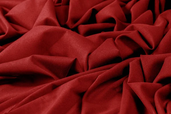 Текстура, фон, рисунок, красная ткань. Элегантные трикотажные материалы — стоковое фото