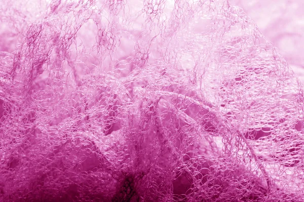 Fabric in a mesh of pink color. this is a micro-thin mesh, which