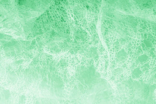 Cloth in a mesh green. Add a line of ethereal brilliance to your — Stock Photo, Image