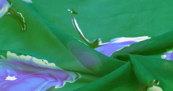 Текстура, фон, зеленая шелковая ткань с синим цветочным принтом . — стоковое фото