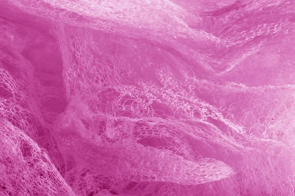 Fabric in a mesh of pink color. this is a micro-thin mesh, which