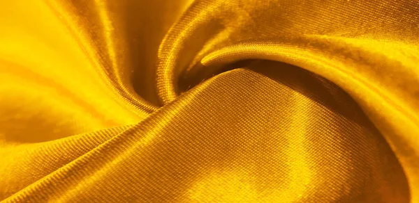 Текстура, фон, узор, шелковая ткань желтого цвета. Это дораb — стоковое фото