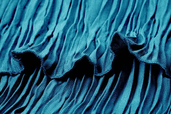Textura, fundo, padrão, pano azul plissado. Um acabamento brilhante Imagem De Stock