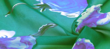 Doku, arka plan, mavi çiçek baskılı yeşil ipek kumaş.
