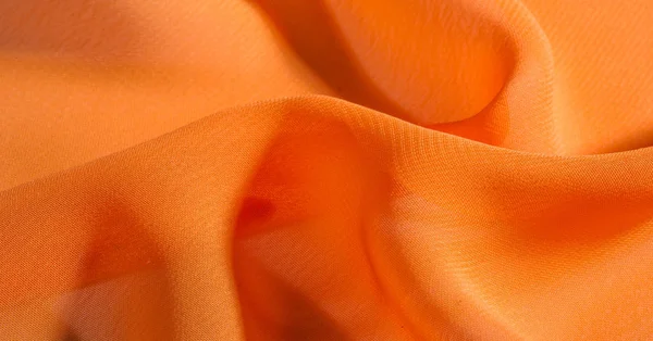 Fond, motif, texture, tissu de soie orange a un brillant — Photo