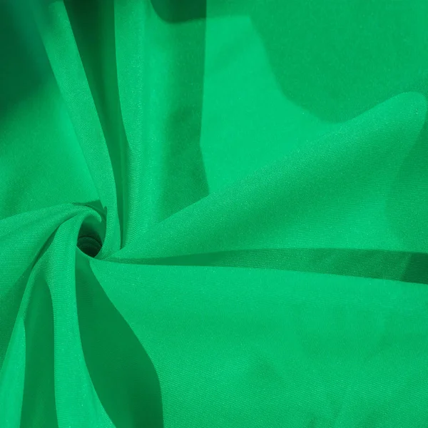 Texture, silk fabric of green color, solid light green silk sati