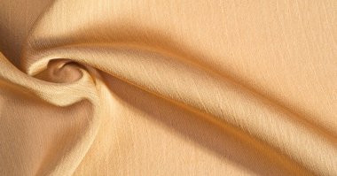 Arka plan, desen, doku, bej altın ipek kumaş Pürüzsüz mat bir kaplamaya sahiptir ve hafif bükümlü bir iplik sayesinde dayanıklıdır. Tasarımdan projelerinize kadar her şey için bu lüks kumaşı kullanın
