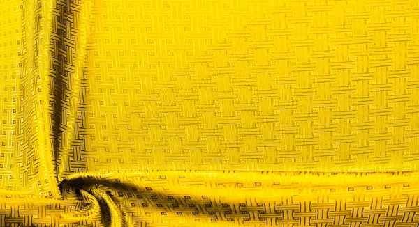 Background texture, pattern. Yellow, mustard silk fabric with a