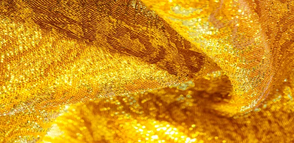 Texture background, pattern. fabric; yellow gold brocade. Organz