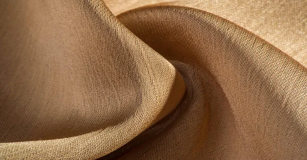 Background, pattern, texture, beige golden silk fabric It has a smooth matte finish and is durable due to a slightly twisted yarn. Use this luxurious fabric for anything - from design to your projects