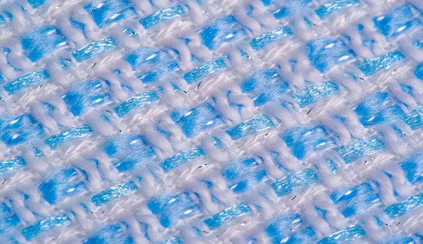 Texture, fabric, pattern. Large weave of blue and white threads,