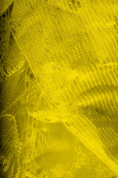 Texture, background, pattern. yellow tulle. With a simple design — Stock Photo, Image