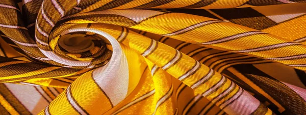 Texture, background, silk fabric with a yellow striped pattern.
