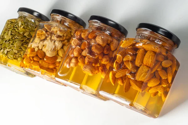 Honey with nuts closed in jars. Good for your health Stock Image