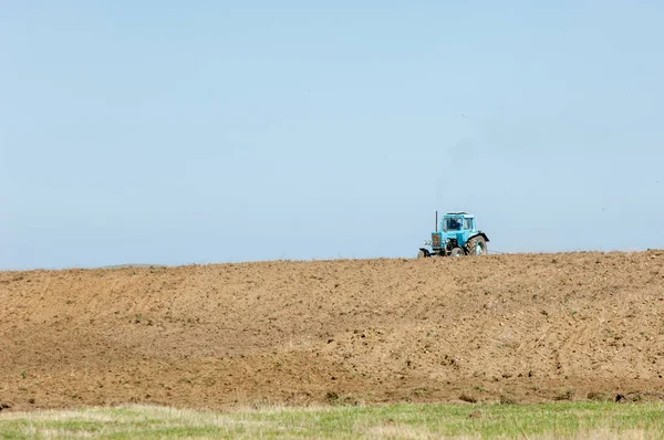 agricultural work in processing, cultivation of land in Kazakhstan. Ploughing heavy tractor during cultivation agriculture works at field with plough