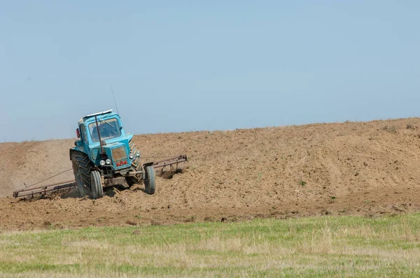 agricultural work in processing, cultivation of land in Kazakhstan. Ploughing heavy tractor during cultivation agriculture works at field with plough