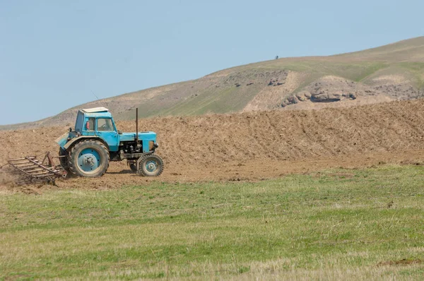 agricultural work in processing, cultivation of land in Kazakhstan. Ploughing heavy tractor during cultivation agriculture works at field with plough