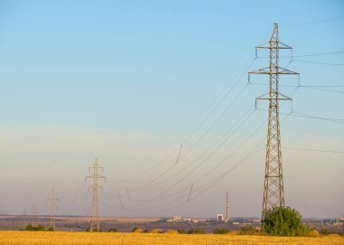Yüksek gerilim enerji nakil hattı. Enerji ayağı. Gün batımında,