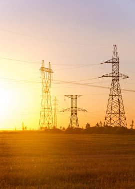 Yüksek gerilim enerji nakil hattı. Enerji ayağı. Gün batımında,