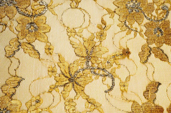 Tekstura. Koronki tkaniny złoty żółty kolor Zdjęcia wykonane w sworzniu — Zdjęcie stockowe
