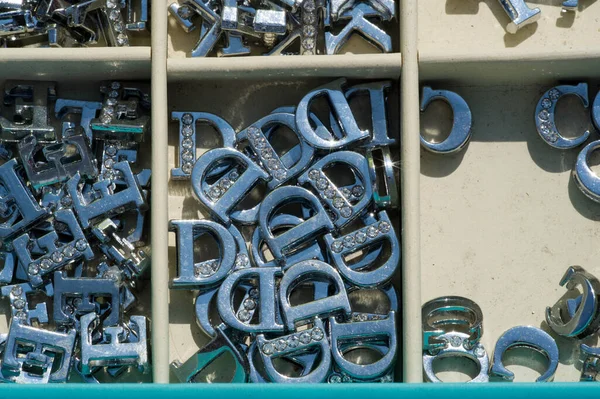 Metal letters for creative work. a characterization of one or more of the sounds used in speech; any of the symbols of an alphabet.