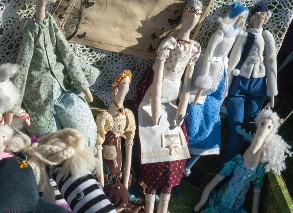 Flea market,  folk crafts. Handmade rag dolls. A rag doll is a children\'s toy. It is a cloth figure, a doll traditionally home-made from (and stuffed with) spare scraps of material.
